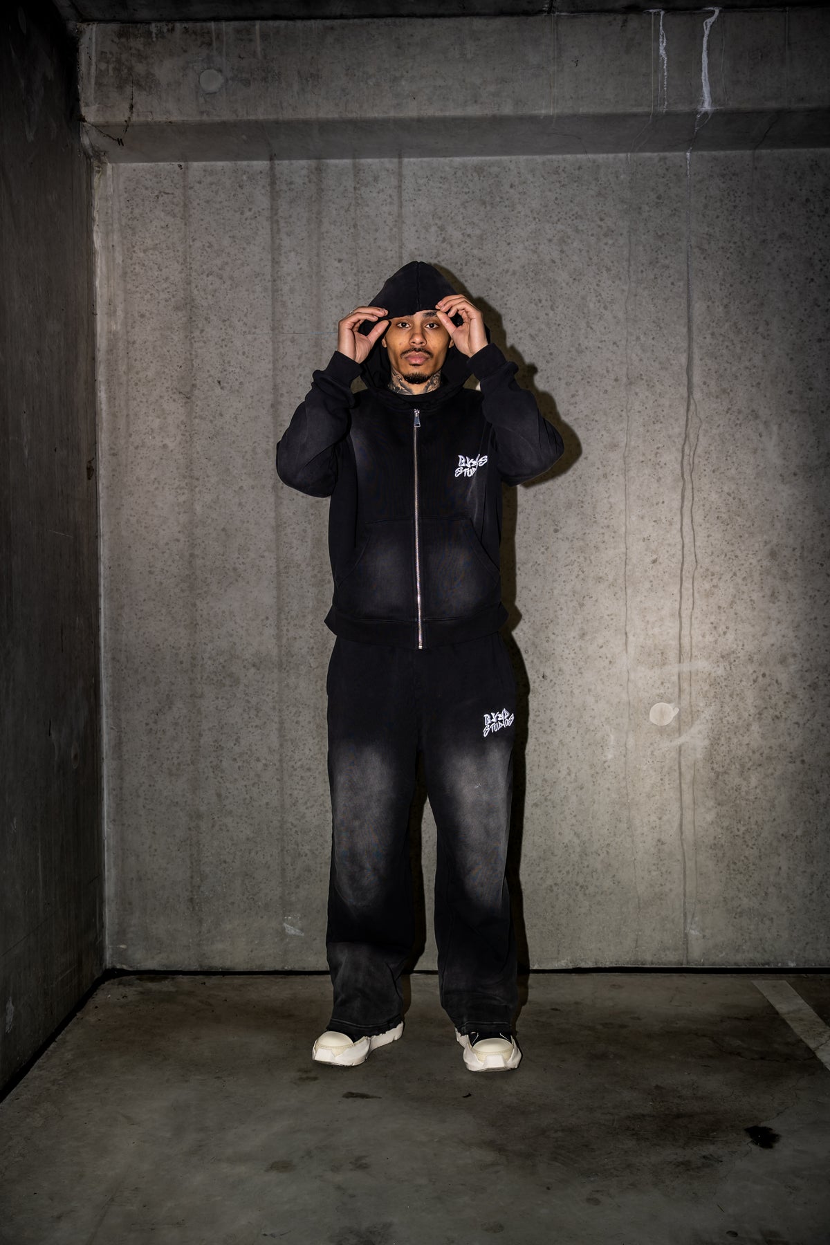Model wearing the BYND STUDIOS Black Set in a concrete room